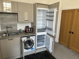 A kitchen with a refrigerator and washing machine at 4 Bickington Road Barnstaple