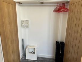 A closet with clothes hangers and a heater at 4 Bickington Road Barnstaple