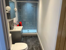 A bathroom with a shower, sink, and toilet at 4 Bickington Road in Barnstaple