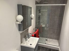 A bathroom with a shower and sink at 4 Bickington Road Barnstaple