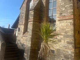 A building with a stone wall and a plant in the outdoor area at 4 Bickington Road Barnstaple
