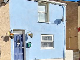 An exterior view of a house with a blue door and window at Blue Haven in Penmaenmawr