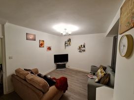 A living room with sofa and television at Blue Haven in Penmaenmawr