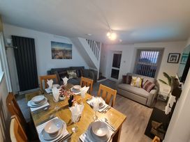 A living room with a dining table and seating area at Blue Haven in Penmaenmawr