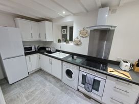 A kitchen with cabinets, appliances and countertop at Blue Haven in Penmaenmawr