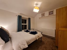 A bedroom with a double bed and a wardrobe at Blue Haven in Penmaenmawr