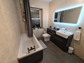 A bathroom with a bathtub, sink, and toilet at Blue Haven in Penmaenmawr