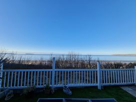 A view of the sea and a beach from the outdoor area at Blue Haven in Penmaenmawr