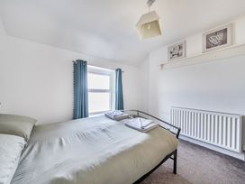 A bedroom with a bed and window at Blue Haven in Penmaenmawr