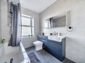 A bathroom with a bathtub, toilet, and sink at Blue Haven in Penmaenmawr