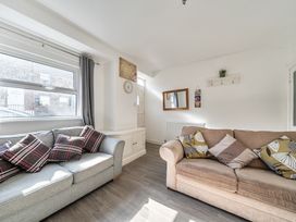 A living room with sofas and a window at Blue Haven in Penmaenmawr
