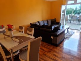 A living room with a dining table and sofa at Sea View Escape in Penmaenmawr