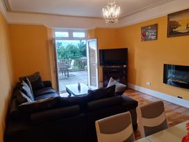A living room with a sofa and television at Sea View Escape in Penmaenmawr