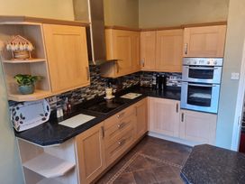 A kitchen with cabinets and appliances at Sea View Escape in Penmaenmawr