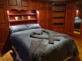 A bedroom with a bed and wardrobe at Sea View Escape Penmaenmawr