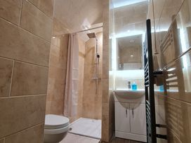 A bathroom with a shower and toilet at Sea View Escape in Penmaenmawr
