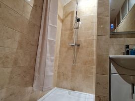 A bathroom with a shower and sink at Sea View Escape Penmaenmawr