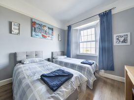 A bedroom with two beds and a window at Sea View Escape in Penmaenmawr