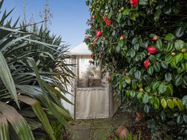 A garden with a tent surrounded by plants at Sea View Escape in Penmaenmawr