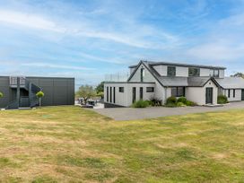 A house with grass and a patio at Huxham View and Annex Stoke Canon