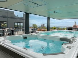 An outdoor area with a spa and seating at Huxham View and Annex Stoke Canon