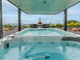 An outdoor space with a swimming pool and oven at Huxham View and Annex Stoke Canon