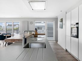 A kitchen with a sink and refrigerator at Huxham View and Annex Stoke Canon