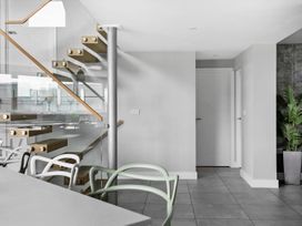 An indoor space with stairs, table, chairs, and a door at Huxham View and Annex, Stoke Canon