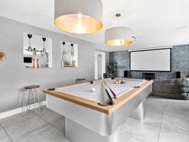 A game room with a pool table and a television at Huxham View and Annex Stoke Canon