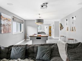A game room with a pool table and seating at Huxham View and Annex Stoke Canon