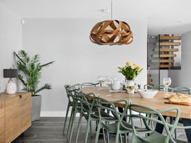 A dining room with a long table and chairs at Huxham View and Annex Stoke Canon