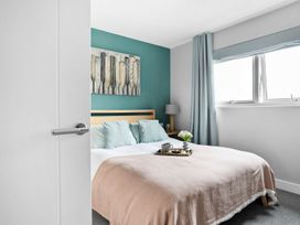 A bedroom with a bed and wall art at Huxham View and Annex in Stoke Canon