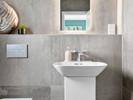 A bathroom with a basin and mirror at Huxham View and Annex Stoke Canon