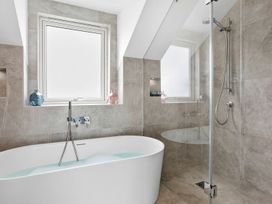 A bathroom with a bathtub and shower at Huxham View and Annex Stoke Canon