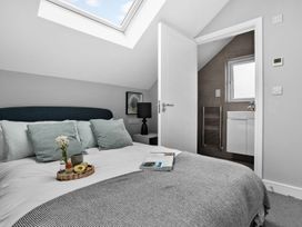 A bedroom with a bed and adjoining bathroom at Huxham View and Annex Stoke Canon