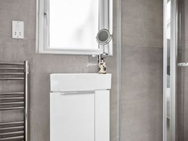 A bathroom with a sink and towel rail at Huxham View and Annex Stoke Canon