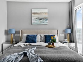 A bedroom with a bed and nightstand at Huxham View and Annex Stoke Canon