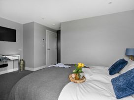 A bedroom with a bed and television at Huxham View and Annex, Stoke Canon