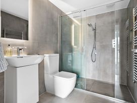 A bathroom with a sink, toilet, and shower at Huxham View and Annex in Stoke Canon