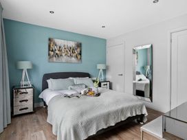 A bedroom with a bed and nightstands at Huxham View and Annex Stoke Canon