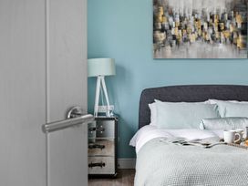 A bedroom with a bed and lamp at Huxham View and Annex in Stoke Canon