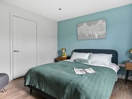 A bedroom with a bed and bedside tables at Huxham View and Annex Stoke Canon