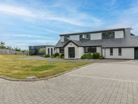 A modern house with a garden and driveway at Huxham View and Annex in Stoke Canon