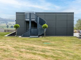 A building with a spiral staircase and landscaped garden at Huxham View and Annex Stoke Canon