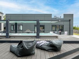 An outdoor area with a pool and seating at Huxham View and Annex Stoke Canon