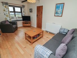 A living room with a sofa and television at Sunny Brae in Alnwick