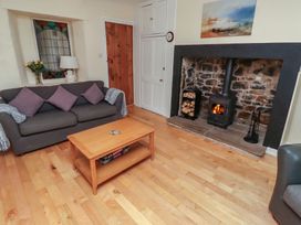 A living room with a fireplace and sofa at Sunny Brae in Alnwick