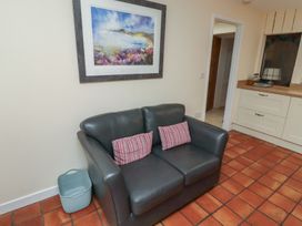 A living room with a sofa and painting at Sunny Brae in Alnwick