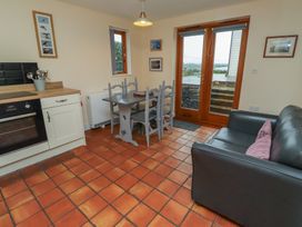 A kitchen with dining area and sofa at Sunny Brae in Alnwick