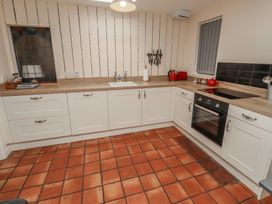 A kitchen with cabinets, oven, sink and countertop at Sunny Brae in Alnwick